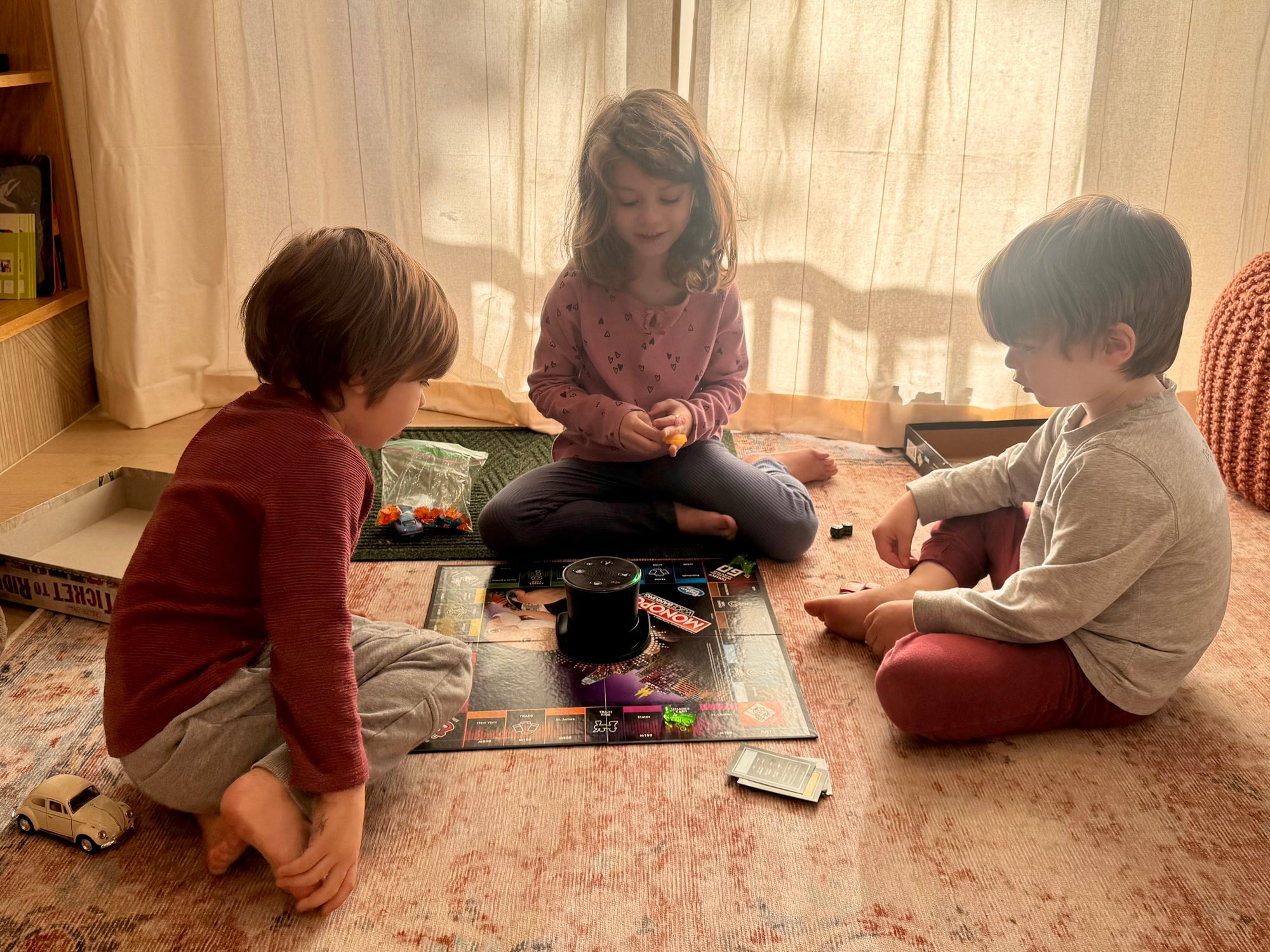 children playing board game in a sunlit room